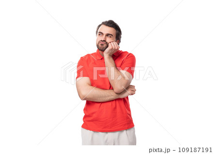 a young smart 35 year old european man with a styled haircut and a beard dressed in a red t-shirt a young smart 35 year old european man with a styled haircut and a beard dressed in a red t-shirt 109187191