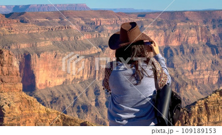 Young woman is overwhelmed by view over the Grand Canyon Young woman is overwhelmed by view over the Grand Canyon 109189153