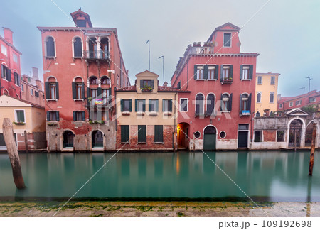 Traditional Venetian houses along the canal on a sunny day. Traditional Venetian houses along the canal on a sunny day. 109192698