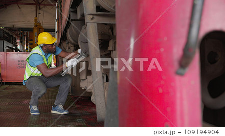 Young black engineer maintenance and repair train diesel engine in station. Young black engineer maintenance and repair train diesel engine in station. 109194904