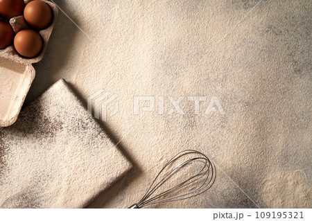 Baking background with flour,cutting board, eggs on a table, flat lay photo view.  109195321