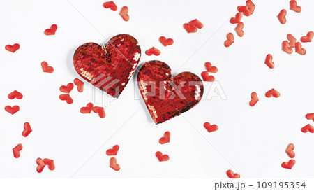 Two big red hearts surrounded by many small hearts on a white background 109195354