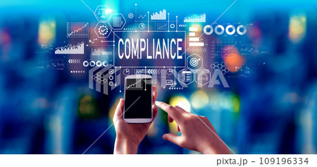 Compliance theme with person using a smartphone at night Compliance theme with person using a smartphone at night 109196334