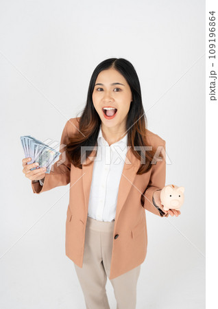 Happy Asian businesswoman holding piggy bank isolated on white background, Saving money concept Happy Asian businesswoman holding piggy bank isolated on white background, Saving money concept 109196864