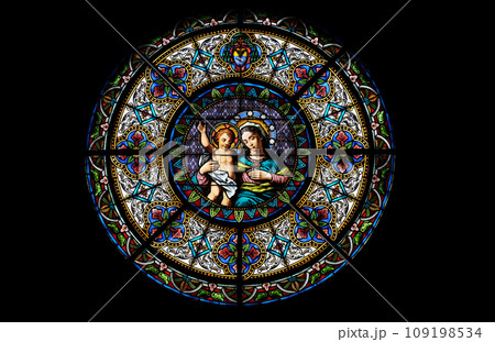 Virgin Mary with baby Jesus, stained glass window in the Cathedral of Saint Lawrence in Lugano, Switzerland Virgin Mary with baby Jesus, stained glass window in the Cathedral of Saint Lawrence in Lugano, Switzerland 109198534