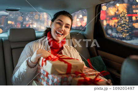 Woman is  holding presents 109201497
