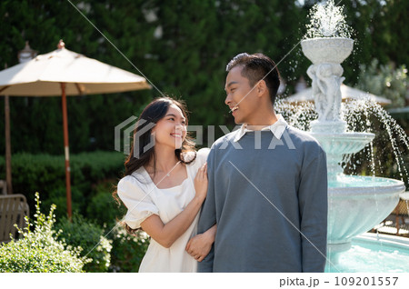 Lovely sweet young Asian couple walking in a beautiful park on a sunny day together. 109201557