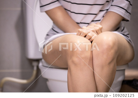 Asian woman urinating in toilet,problem of Polyuria,urination disorders,frequent micturition,urinary incontinence,urinary urgency,overactive bladder,urine frequency,kidney and urinary bladder system 109202125