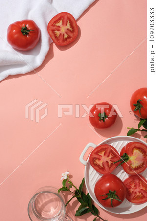 Creative scene for advertising natural ingredient with tomato. Pink background with copy space. Tomatoes bring many health benefits, high nutritional content and help the body fight many diseases. Creative scene for advertising natural ingredient with tomato. Pink background with copy space. Tomatoes bring many health benefits, high nutritional content and help the body fight many diseases. 109203333