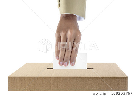 Human hand inserts vote paper into ballot box 109203767