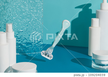 Minimalist elegance: Razor in sharp relief against a bold blue backdrop with dramatic shadows 109204039