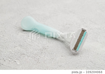 High-quality razor showcased on a sophisticated gray backdrop. Grooming routine with style and precision 109204068