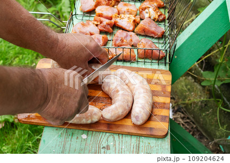 Meat and sausage on a grill closeup 109204624