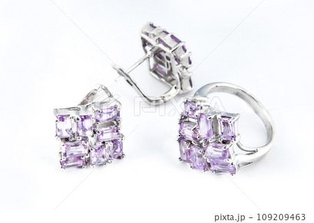 Elegant jewelry set of white gold ring, necklace and earrings with diamonds. Silver jewellery set with gemstones. Product still life concept Elegant jewelry set of white gold ring, necklace and earrings with diamonds. Silver jewellery set with gemstones. Product still life concept 109209463