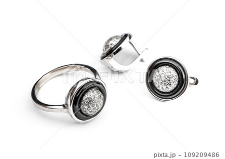 Silver jewelry set of ring and silver earrings with stones on white background. Silver jewelry set collection 109209486