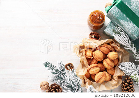 Nuts cookies on the table with a Christmas tree branch 109212036