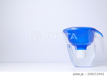 Water filter with a blue cap on a white background 109213042