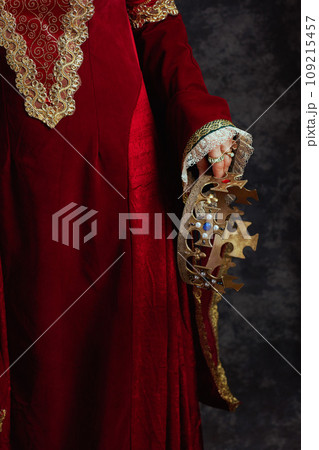 Closeup on medieval queen in red dress with crown 109215457