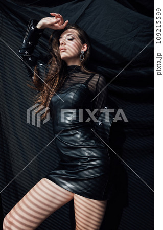 Beautiful brunette woman posing on black background Beautiful brunette woman posing on black background 109215599