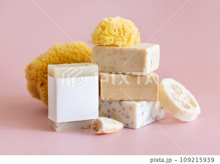 Soap bars with blank label, natural sponge and seashell on pink close up, mockup 109215939