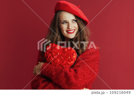 smiling elegant woman in sweater and beret hugging heart smiling elegant woman in sweater and beret hugging heart 109216049