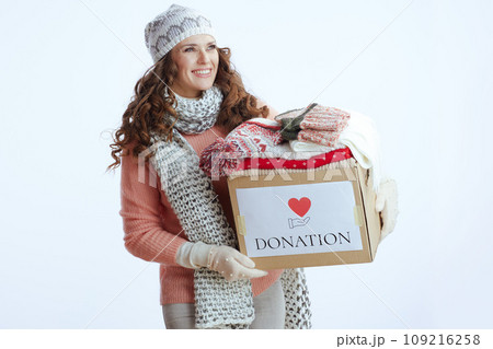 happy stylish woman in sweater, mittens, hat and scarf on 109216258
