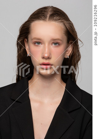 Portrait of a beautiful blonde girl with blue eyes and clear skin. A seventeen year old girl. Slavic appearance of a young beauty. 109216296