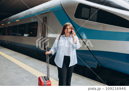 Young worried female traveler lost at railroad station platform. Upset woman talking over phone disappointed hear bad news, sad pensive girl speaking having unpleasant phone conversation 109216948