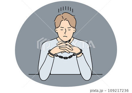 Unhappy man in handcuffs sit at table Unhappy man in handcuffs sit at table 109217236