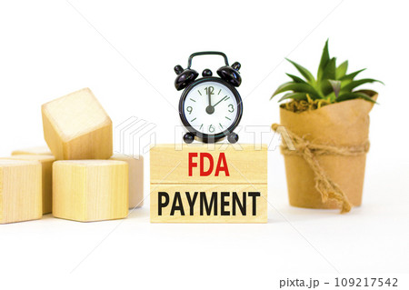 FDA Food and Drug Administration payment symbol. Concept words FDA payment on beautiful wooden blocks. Beautiful white table background. Black alarm clock. Business FDA payment concept. Copy space. FDA Food and Drug Administration payment symbol. Concept words FDA payment on beautiful wooden blocks. Beautiful white table background. Black alarm clock. Business FDA payment concept. Copy space. 109217542