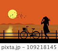 Silhouette of woman and bicycle standing by the sea watching the sunset. 109218145