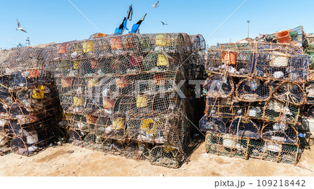 Prawn and shrimp traps at the fishing port of Essaouira, Morocco. Fishermen strategically place the prawn traps on the ocean floor, often baiting them to attract the prawns. 109218442