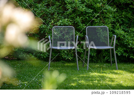 Metal chairs in spring garden. Metal garden furniture for picnics and birdwatching 109218595