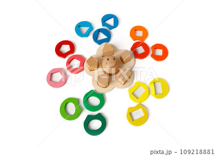 Wooden puzzle toy that develops logic and fine motor skills with colorful blocks of different shapes isolated on white background 109218881