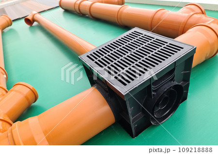 Underground French Drain System, street sewer plastic pipes assembled together with a water inlet at the store stand 109218888