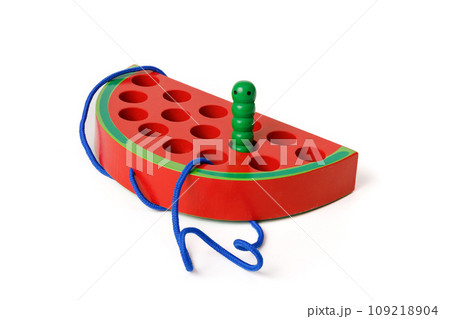 Kid's wooden Montessori toy in the shape of a red watermelon with a funny worm on a rope, toy for fine hand motor skills, isolated on white background Kid's wooden Montessori toy in the shape of a red watermelon with a funny worm on a rope, toy for fine hand motor skills, isolated on white background 109218904