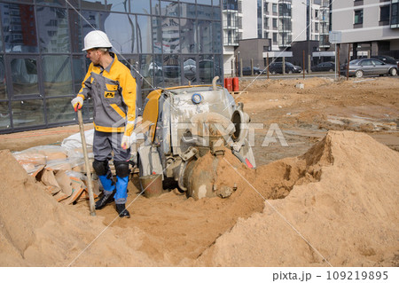 A builder in work clothes is doing his job A builder in work clothes is doing his job 109219895