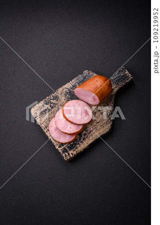 Delicious smoked sausage with salt and spices cut into slices 109219952