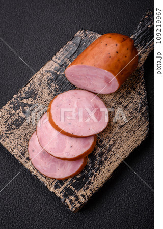 Delicious smoked sausage with salt and spices cut into slices Delicious smoked sausage with salt and spices cut into slices 109219967