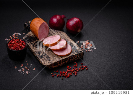 Delicious smoked sausage with salt and spices cut into slices Delicious smoked sausage with salt and spices cut into slices 109219981