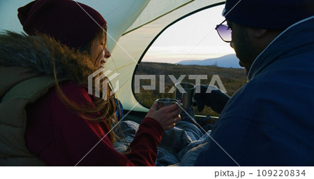 Caucasian woman holding cup and talking with African American man 109220834