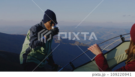 Multiethnic backpacker friends rest during a hike Multiethnic backpacker friends rest during a hike 109220941