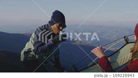 Multiethnic backpacker friends rest during a hike 109220943