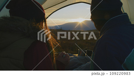 Close up of African American man sitting in tent with Caucasian wife 109220983