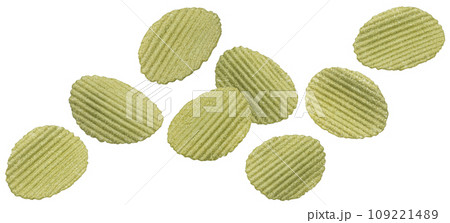 Falling green vegetable chips isolated on white background Falling green vegetable chips isolated on white background 109221489