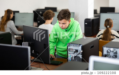 Portrait of students at computers in computer class Portrait of students at computers in computer class 109222108