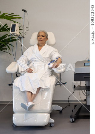 Beautiful woman during medical procedure in wellness center. Beautiful woman during medical procedure in wellness center. 109223948