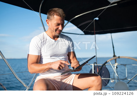 Charismatic man in white clothes on a yacht Charismatic man in white clothes on a yacht 109224126