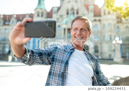 Man making selfie with city on background. 109224431
