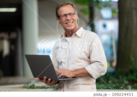 Man working online with laptop computer outdoor. Man working online with laptop computer outdoor. 109224451